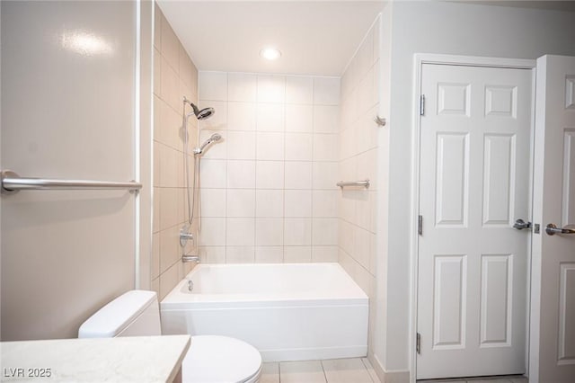 full bathroom featuring tile patterned floors, vanity, tiled shower / bath combo, and toilet