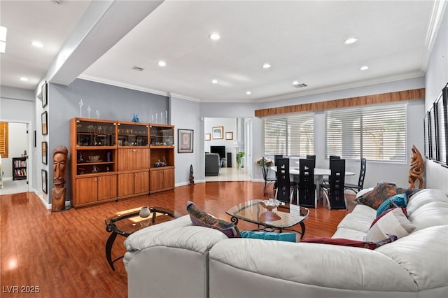 living room featuring hardwood / wood-style floors and crown molding