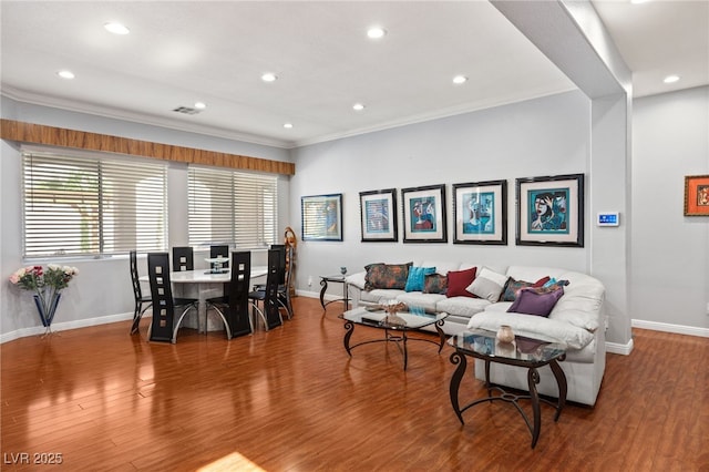 living room with hardwood / wood-style flooring and crown molding