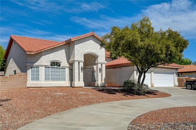 mediterranean / spanish home featuring a garage