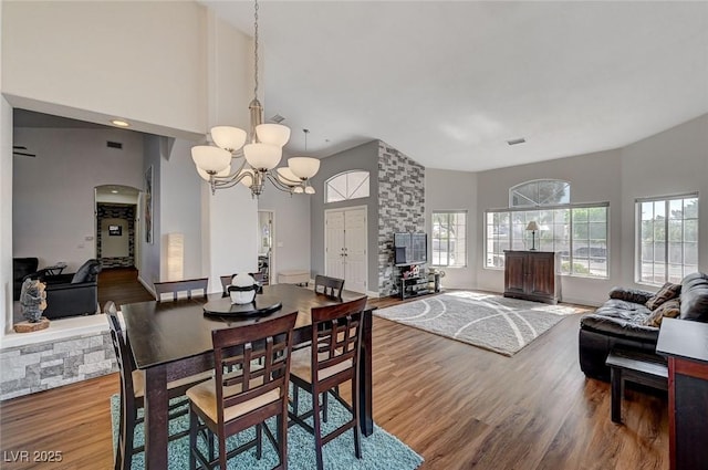 dining room with wood-type flooring and a notable chandelier