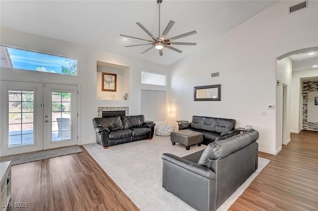 living room with french doors, high vaulted ceiling, ceiling fan, and hardwood / wood-style floors