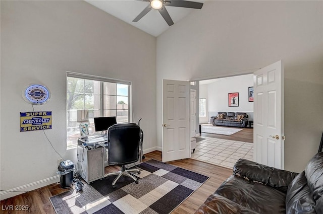 office space with hardwood / wood-style floors, high vaulted ceiling, and ceiling fan