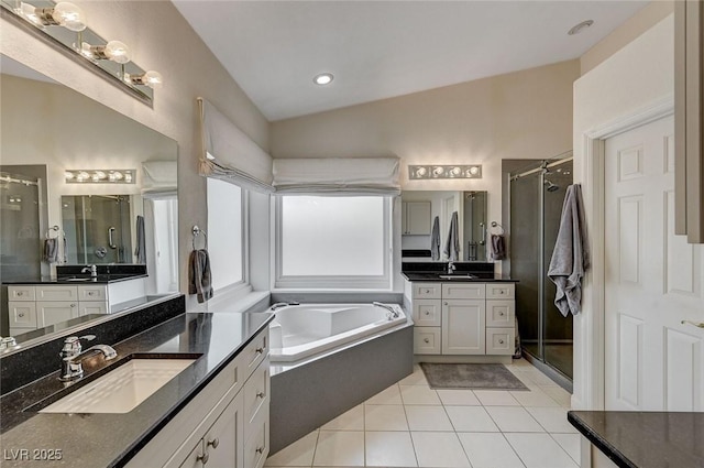 bathroom featuring tile patterned floors, vanity, lofted ceiling, and shower with separate bathtub