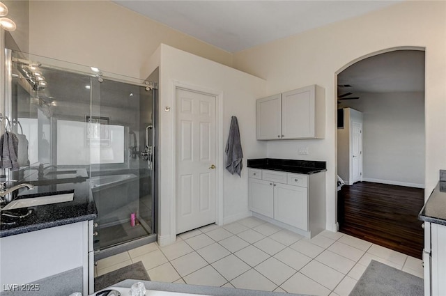 kitchen featuring ceiling fan, light tile patterned flooring, and sink