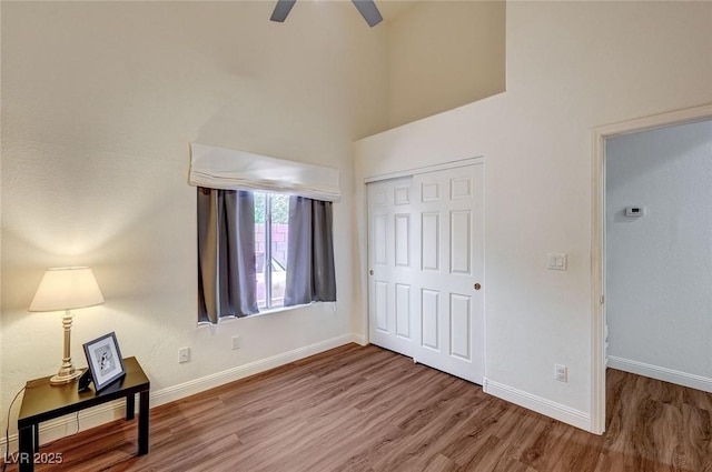 bedroom featuring hardwood / wood-style flooring, a closet, and ceiling fan