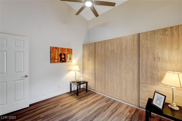 interior space with hardwood / wood-style floors, ceiling fan, and vaulted ceiling