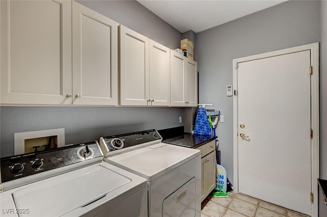 washroom featuring cabinets and independent washer and dryer