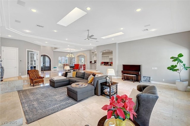 living room featuring ceiling fan with notable chandelier