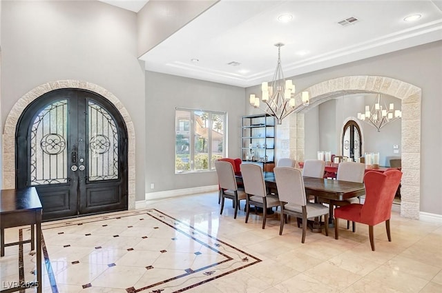 dining area featuring an inviting chandelier and french doors