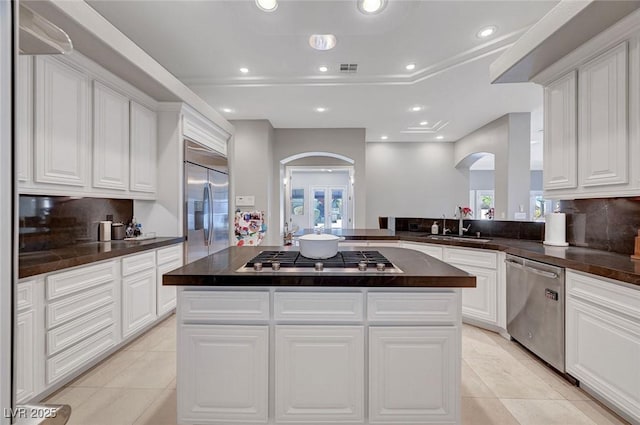 kitchen featuring white cabinets, a center island, and stainless steel appliances