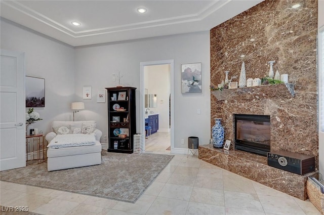 tiled living room with a raised ceiling and a premium fireplace