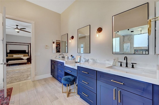 bathroom featuring hardwood / wood-style floors, ceiling fan, and vanity