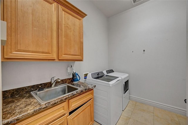 laundry area featuring cabinets, light tile patterned floors, washing machine and dryer, and sink