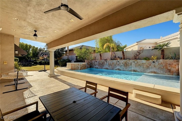 view of patio / terrace featuring pool water feature, a fenced in pool, and ceiling fan