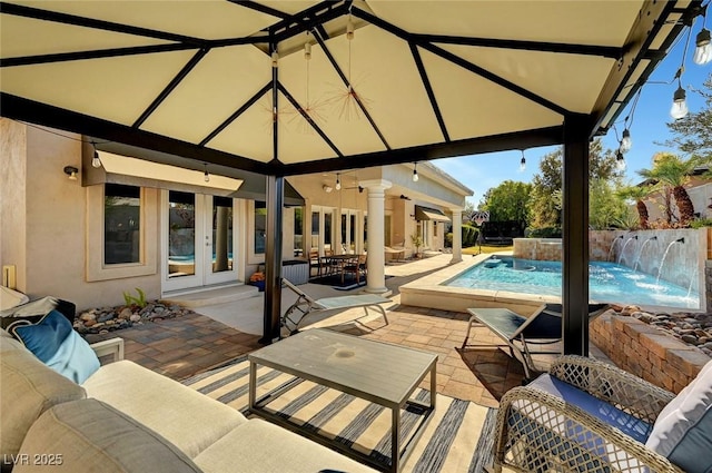 view of pool featuring outdoor lounge area, pool water feature, french doors, and a patio