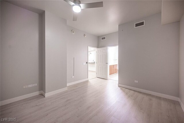 empty room with light hardwood / wood-style flooring and ceiling fan