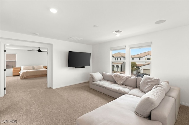 carpeted living room featuring ceiling fan