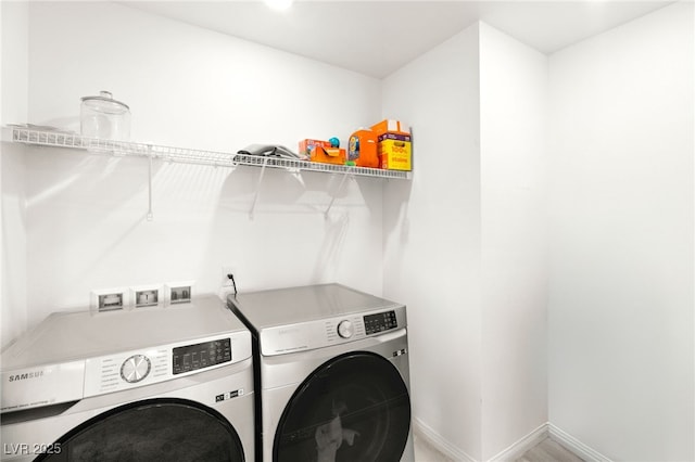 clothes washing area featuring washer and clothes dryer