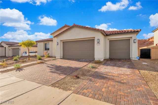 mediterranean / spanish-style house with a garage