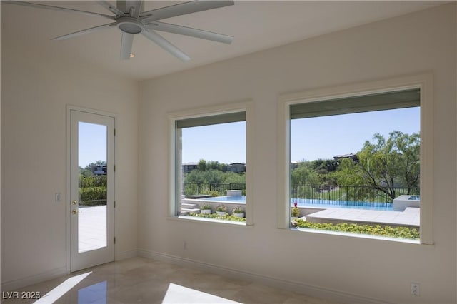 interior space featuring ceiling fan and a wealth of natural light