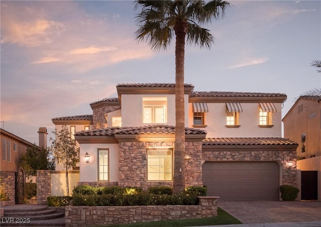 mediterranean / spanish house featuring a garage