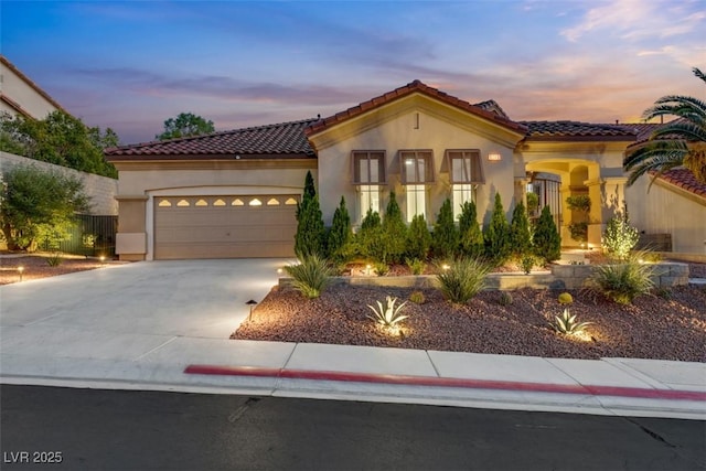 mediterranean / spanish home featuring a garage