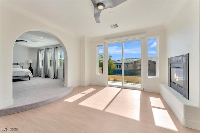 interior space with light hardwood / wood-style floors, ceiling fan, and ornamental molding