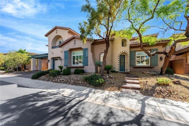 mediterranean / spanish-style home featuring a garage