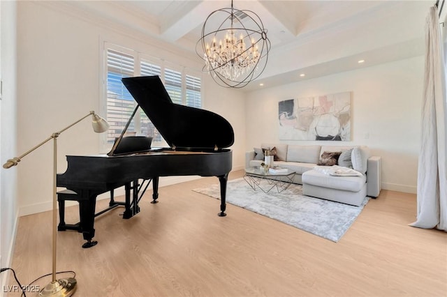 living area featuring hardwood / wood-style floors, beam ceiling, crown molding, and an inviting chandelier