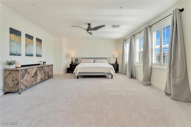 carpeted bedroom with ceiling fan and crown molding