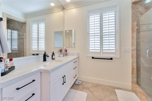 bathroom with tile patterned floors, vanity, an enclosed shower, and a wealth of natural light