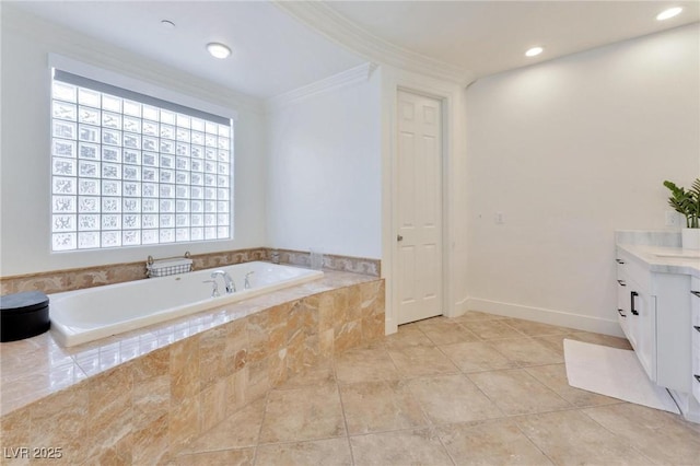 bathroom with vanity, crown molding, and tiled tub