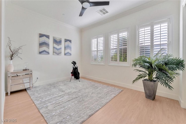 sitting room featuring ceiling fan, wood-type flooring, and crown molding