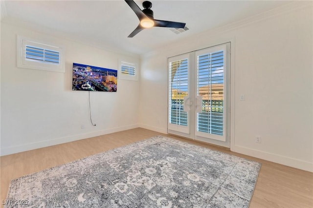 spare room featuring ceiling fan, wood-type flooring, and ornamental molding