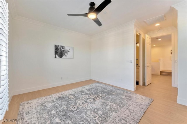 spare room featuring ceiling fan, light wood-type flooring, and ornamental molding