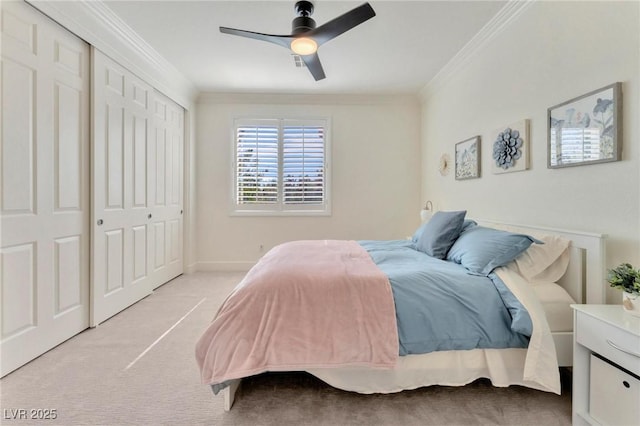 carpeted bedroom featuring a closet, ceiling fan, and crown molding