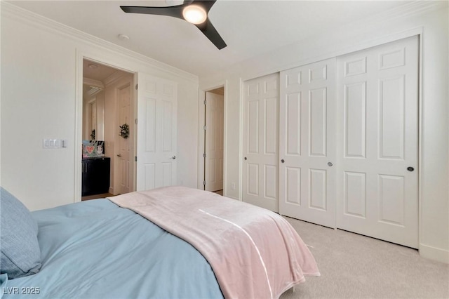 carpeted bedroom featuring ceiling fan and ornamental molding