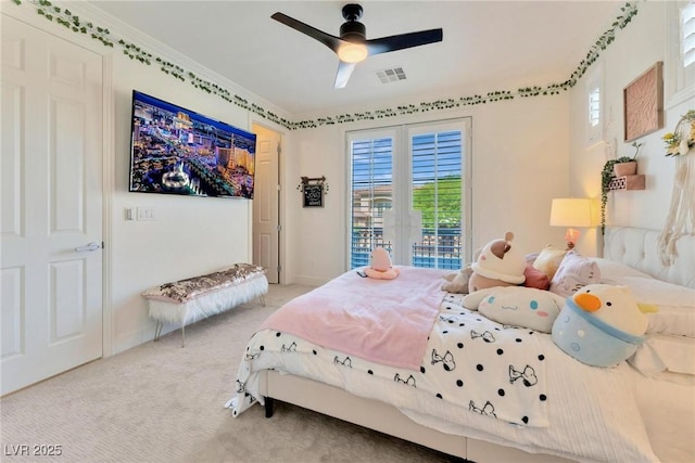 carpeted bedroom featuring ceiling fan and crown molding