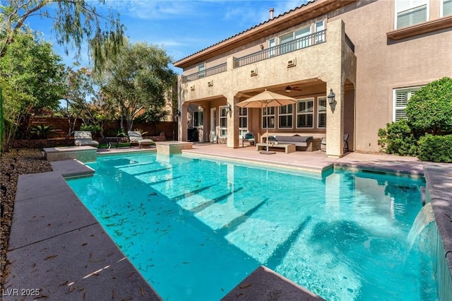 view of swimming pool featuring an outdoor living space, ceiling fan, and a patio area