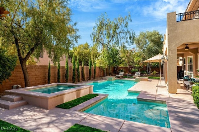 view of pool featuring ceiling fan, a patio area, and an in ground hot tub