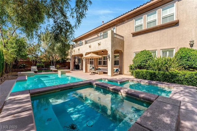 view of pool featuring a patio area, an outdoor hangout area, and an in ground hot tub