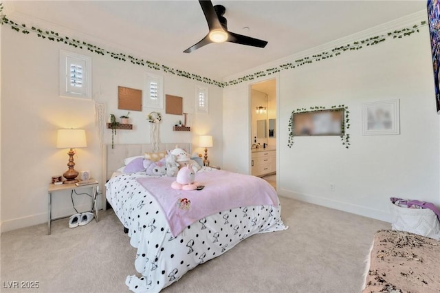 carpeted bedroom with multiple windows, ensuite bath, ceiling fan, and crown molding