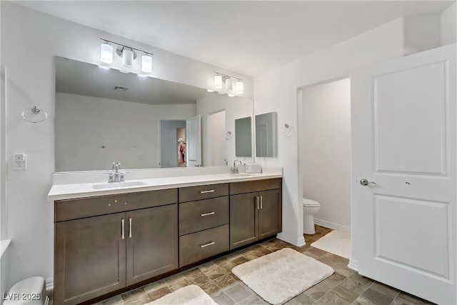 bathroom with vanity and toilet