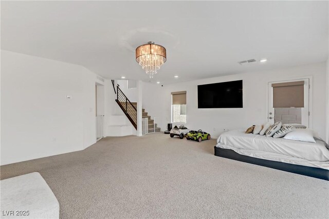 bedroom featuring carpet floors and an inviting chandelier