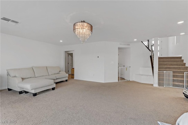 living room featuring light carpet and a notable chandelier