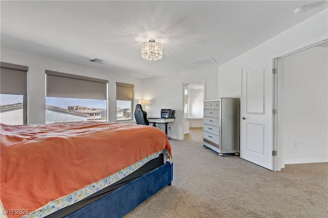 bedroom featuring ensuite bathroom, multiple windows, light carpet, and a chandelier