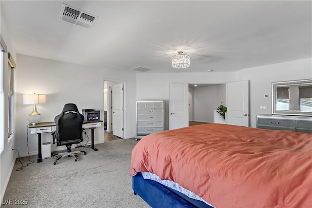 carpeted bedroom with an inviting chandelier