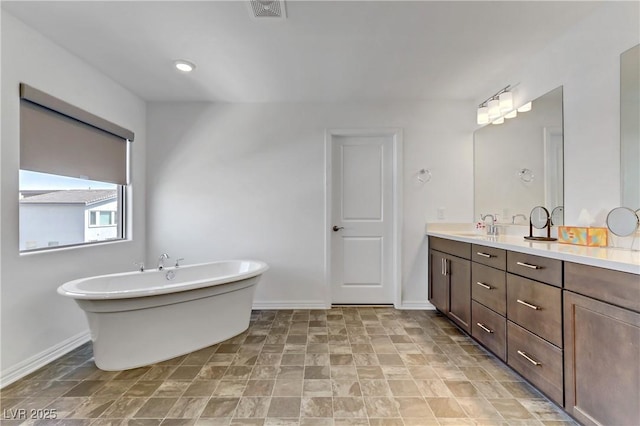 bathroom with vanity and a tub