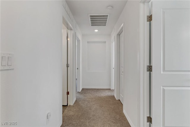 hallway featuring light carpet